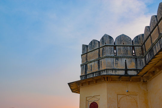 A beautiful view of the upper part of The Kumbhalgarh Fort with fortified walls and sky in background.