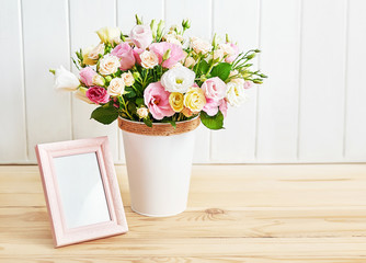 Flowers and photo frame, women's day. Mother's day greeting card. Bouquet of flowers eustoma and roses in vase. Happy Birthday! Valentine's day gift. 14 February. I love you concept. Flower delivery