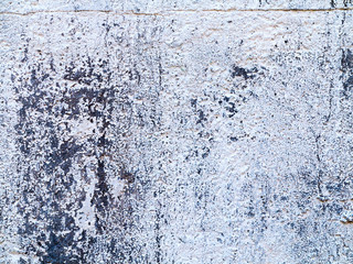 Background concrete wall, traces of weathering, worn wall damaged paint old paint. Remains of old paint on the painted concrete surface. Grungy concrete surface.