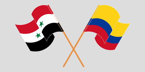 Crossed and waving flags of Syria and Colombia