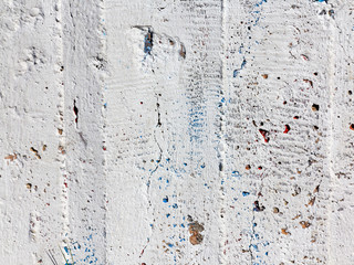 Background concrete wall, traces of weathering, worn wall damaged paint old paint. Remains of old paint on the painted concrete surface. Grungy concrete surface.