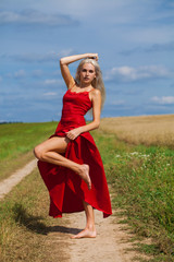 portrait of a young beautiful blonde woman in red dress