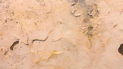 Background concrete wall, traces of weathering, worn wall damaged paint old paint. Remains of old paint on the painted concrete surface. Grungy concrete surface.