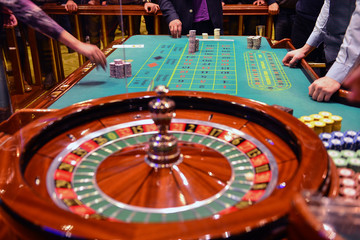 green roulette table with colored chips ready to play
