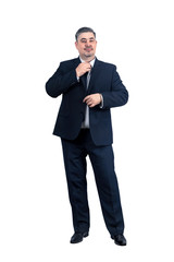 A man in a suit straightens his tie and looks at the camera