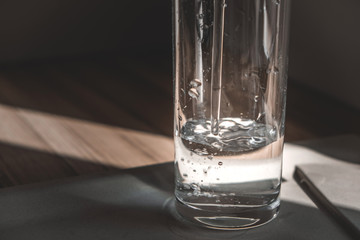 a glass is filled with crystal clear water in the morning sun. a glass of water in the morning. healthy eating, health care