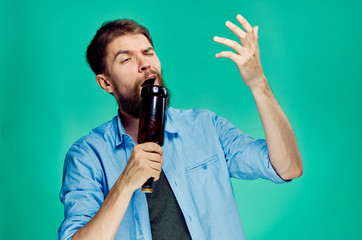 drunk man with a bottle of beer in his hand depicts singing green background