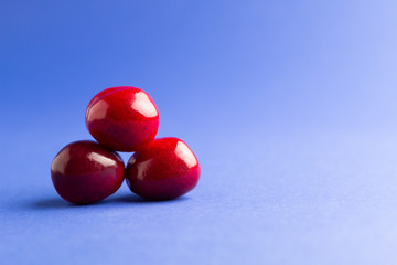 Fresh cherry berries on a blue background.Side view.
