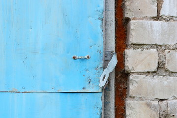 Old metal blue door in an abandoned building