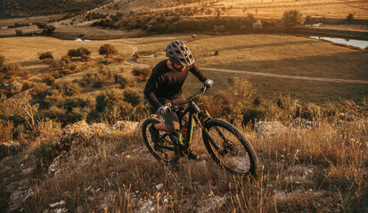 Fototapeta na wymiar Man with mountain bike climbing hill