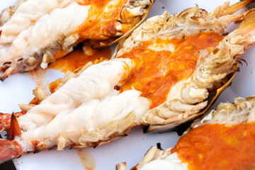 Grilled giant river shrimp or prawn with spicy seafood on wooden table at resturant in  Thailand