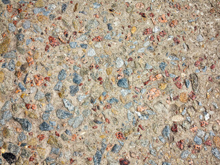 textured background concrete surfaces interspersed with small stones