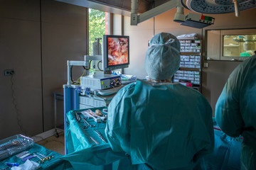 medical team operates on a patient endoscopically in an operating room