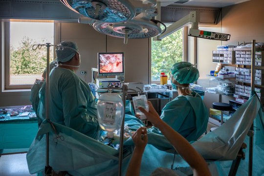 medical team operates on a patient endoscopically in an operating room