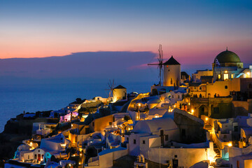 famous view over the village of Oia at the Island Santorini in twilight time, Greece, Europe, Traveling concept - obrazy, fototapety, plakaty