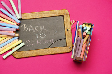 top view of blackboard with chalks and back to school message. flat lay. flat design