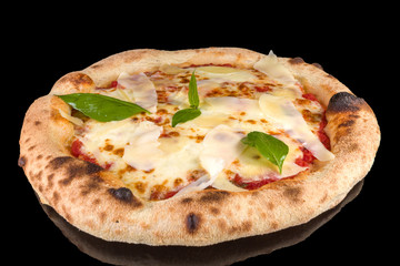 Delicious pizza Quattro formaggi with tomato sauce, parmesan, mozzarella, stracciatella provolone and fresh basil, with reflection, isolated on black background