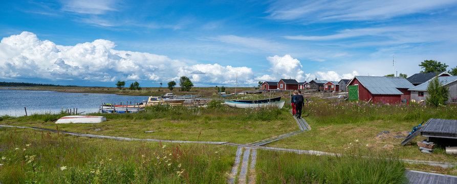 Traditional Fishing Village and Boat houses by the lake in Sweden on Stor-Rabben Island, Near Pitea in the Archipelago of Gulf of Bothnia in Northern Scandinavia.