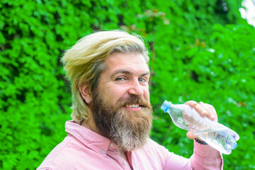 Stay hydrated. Health care concept. Man drink water outdoor. Man with water bottle. Healthy lifestyle. Drinking water. Bearded man drinking water. Hydration concept.