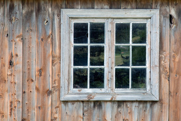 old white Window on wooden wall..