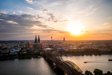 Aerial view of Cologne Cathedral and Hohenzollern Bridge at sunset, Germany