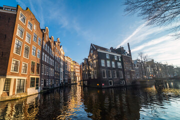 Obraz premium Amsterdam Netherlands dancing houses over river Amstel landmark in old european city