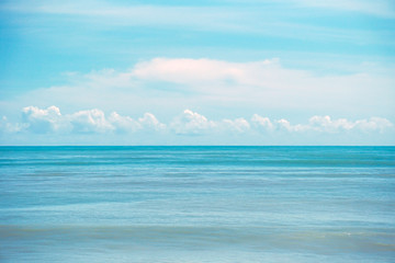 Obraz premium Beautiful white clouds on blue sky over calm sea, Tranquil sea harmony of calm water surface.
