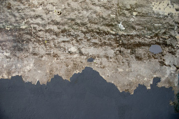 Abstract concrete wall with remnants of old gray paint (grunge effect)