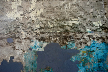 Abstract concrete wall with remnants of old blue and gray paint (grunge effect)