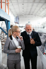 Man and woman discussing work. Colleagues working in factory