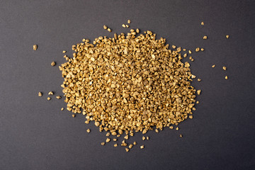 Gold granules on gray background