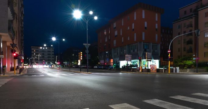 Timelapse view of traffic at an urban night intersection. Urban movement in the Italian city in the evening.Time Lapse 4k