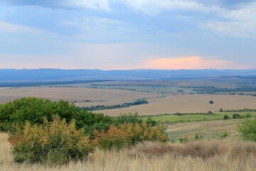 Fototapeta premium View of the plain from a height in the vicinity of the village of Avren (Bulgaria) at sunset