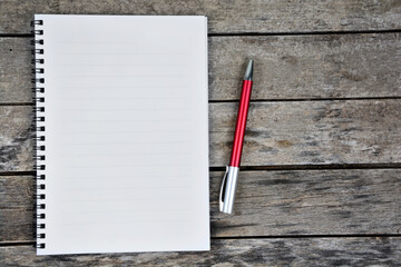 Empty notebook page on a wooden table