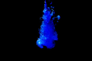 A cloud of blue paint released into clear water. Isolate on a black background.