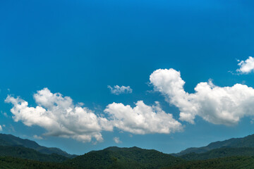 Blue sky background with clouds over the mountain