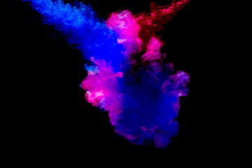 A cloud of pink and blue paint released into clear water. Isolate on a black background.
