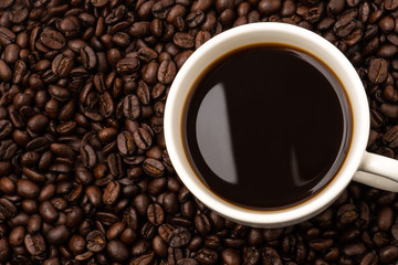 Cup of coffee with coffee beans background