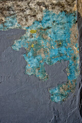 Remnants of old blue and gray paint on concrete wall (grunge effect)