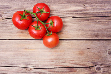 Close-up of fresh, ripe cherry tomatoes on wood