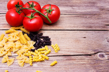 Different pasta from Italy on a wooden table with tamatami