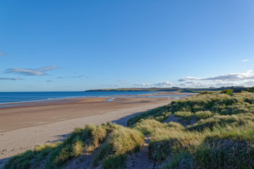 St Cyrus Beach in Aberdeenshire looking South on one Fine Autumn day, with the exposed beach from the low tide stretching away into the Distance.
