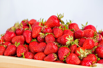 Ripe strawberries ready for eating in wooden boxes. Red ripe strawberries closeup. Selective focus. You can use as the background for any of Your project.