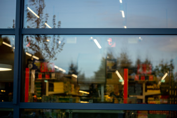 supermarket store windows with lights and advertisements inside