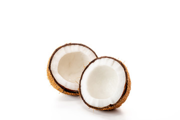 Coconut on a black background. Chopped coconut. Several parts. Stone surface. Fresh coconut. White pulp.