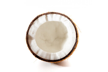 Coconut on a black background. Chopped coconut. Several parts. Stone surface. Fresh coconut. White pulp.