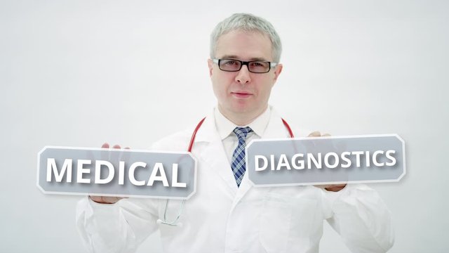 Male doctor holds MEDICAL DIAGNOSTICS text in his hands