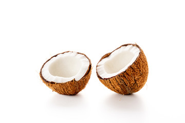 Coconut on a black background. Chopped coconut. Several parts. Stone surface. Fresh coconut. White pulp.