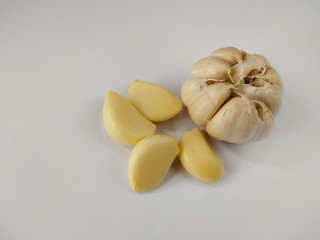 Closeup peeled garlic (Allium sativum) on a white background. garlic as a seasoning for flavoring food