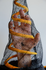Scary hand inside a mesh hat for Halloween.